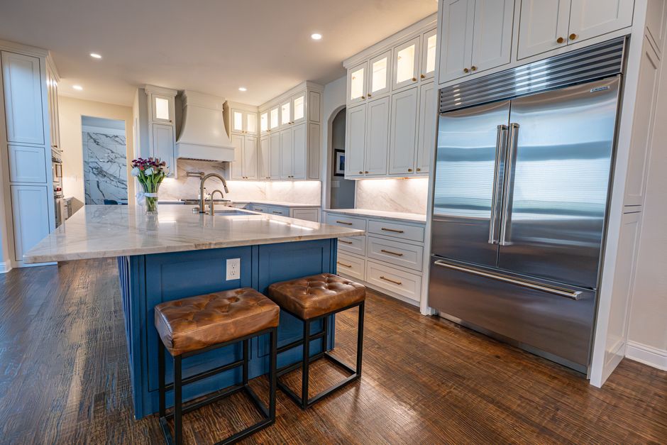 Spacious kitchen with marble countertops, a center island and stainless steel appliances